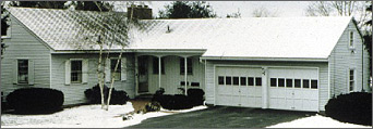 Photo of a ranch style house in winter.